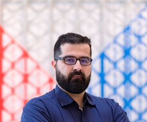 Hasan Al-Khoee in a blue shirt posing for a photo 