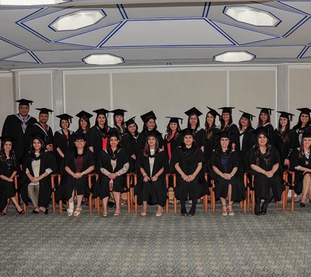 A bunch of graduates posing for a photo in their convocation gowns