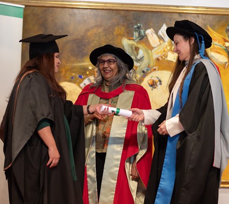 Professor Kassam and Dr Dildobekova present a STEP student with her award. 
