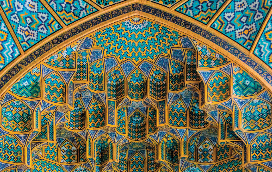 An image of a ceiling from an architectural building with sections of blue shaded tiles and golden border around them