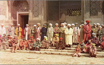 An Ivanow gallery colourful image with a group of people in Arab dressing standing near a Muslim monument in Adab (respectful) gesture