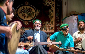 Five musical school players dressed in middle eastern attire playing diverse musical instruments with passion