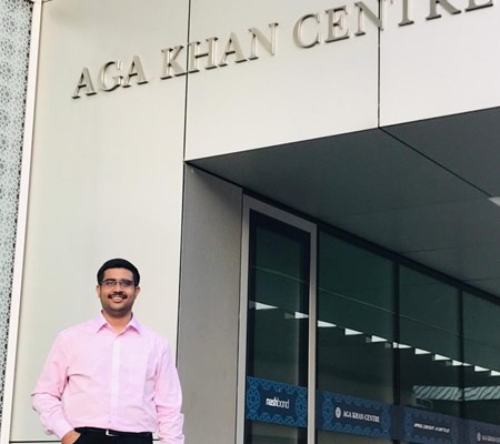 A STEP student posing near the entrance of the AgaKhan Centre