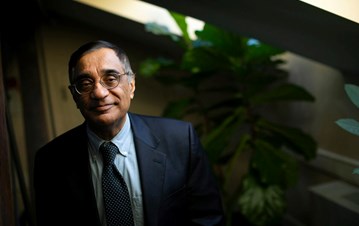 Landscape photo of Professor Ali Asani in a black suit