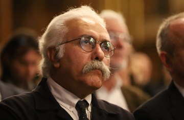 Prof. Mohammad Ali Amir-Moezzi sitting in an inauguration ceremony for his appointment as Chevalier at Institut Français Islamologie