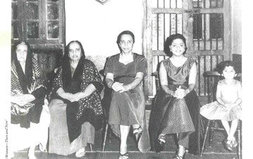 A b/w picture of five women from different generations sitting in a row depicting cultural evolution through their dressing styles