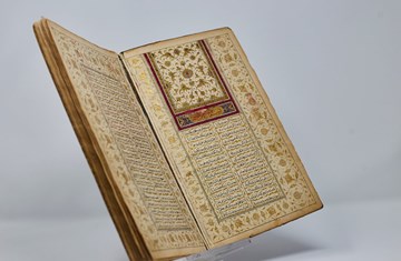 An open book with two pages side by side with Arabic text on it.