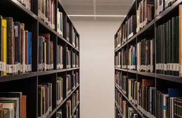 Two book shelves standing across each other.