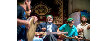 Five musical school players dressed in middle eastern attire playing diverse musical instruments with passion