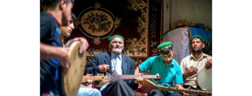 Five musical school players dressed in middle eastern attire playing diverse musical instruments with passion