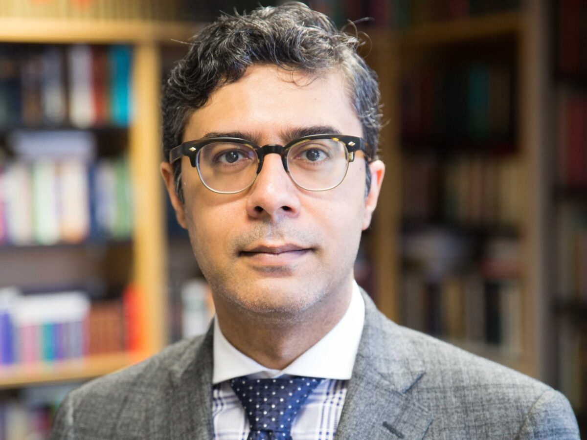 Mr. Zulfikar Khimani in a grey suit and blue tie