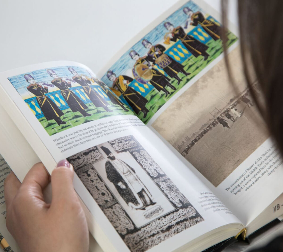 A female scholar reading a book borrowed from IIS library