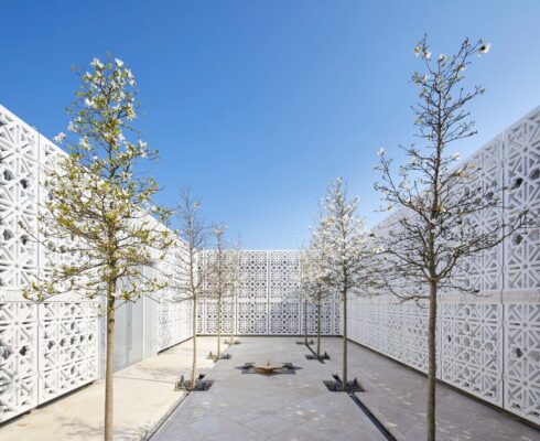 a white courtyard with trees