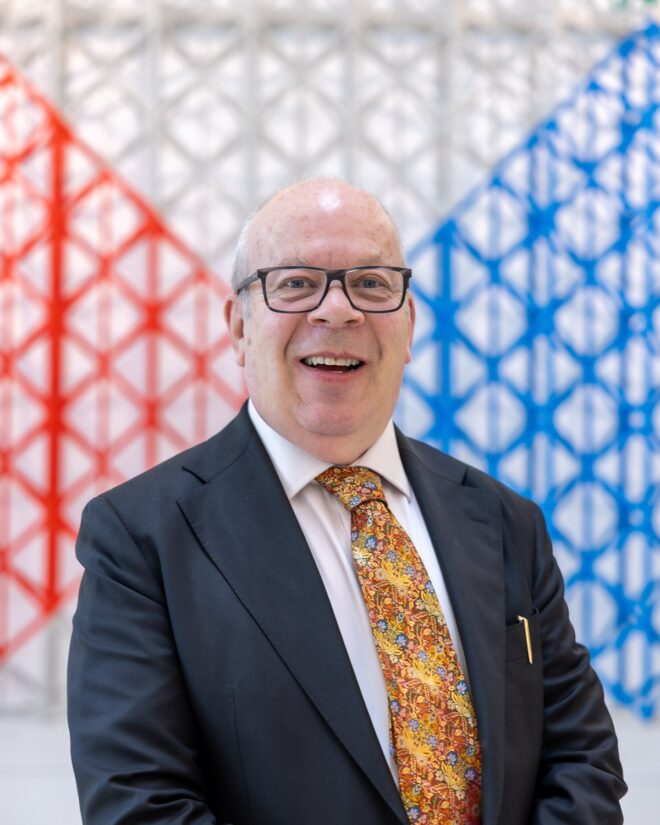 Smartly dressed man with patterned tie.