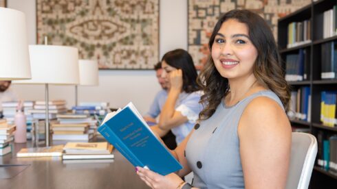 Nosheen Karimi, STEP C18 student, holding a book in the Aga Khan Library.