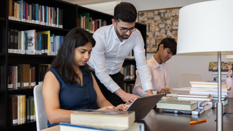 STEP students Sania, Esmail and Shejan working together in the Aga Khan Library.