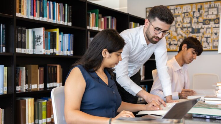 STEP C18 students Sania Bhimani and Esmail Haider discussing their studies in the Aga Khan Library.