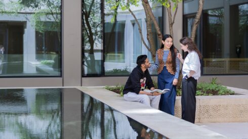 STEP students talking beside a water feature on the first floor of Victoria Hall accomodation.