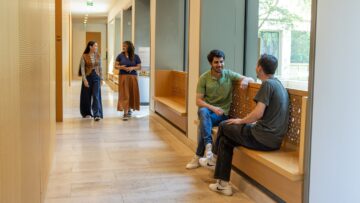STEP C18 students walking and talking in Victoria Halls accommodation.