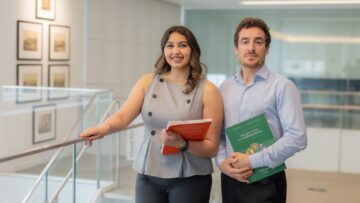 Nousheen Karimi and Ahmad Ali, STEP C18 students, holding Secondary Curriculum books in the Aga Khan Library.