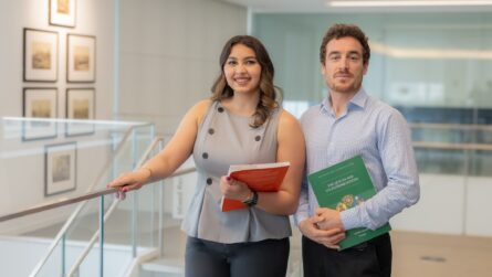 Nousheen Karimi and Ahmad Ali, STEP C18 students, holding Secondary Curriculum books in the Aga Khan Library.