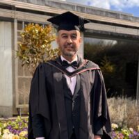 Ahmed Nayyar, STEP C17 alumnus, in graduation gown and cap at the Ismaili Centre.