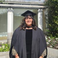 Nabila Esmail, STEP C16 alumna, in graduation gown and cap.