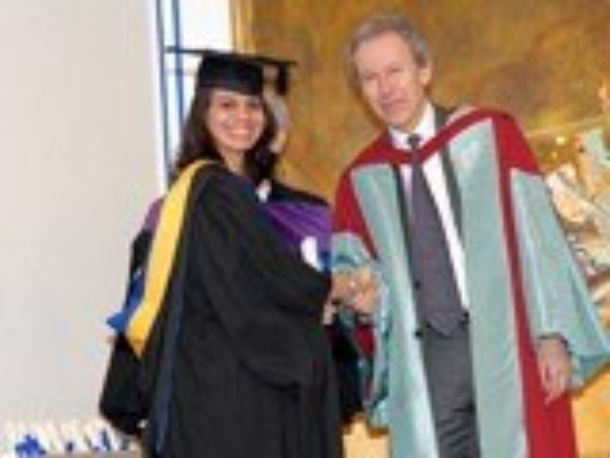 A student receiving award from the scholar Dr. Farhad Daftary