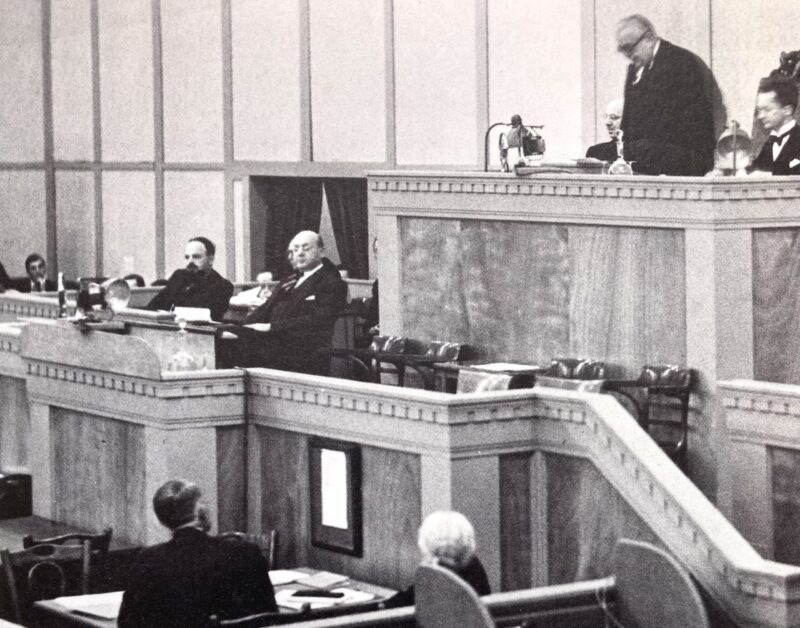 Aga Khan III seen addressing the League of Nations Assembly at the Palace of Nations during his term as President of the League.