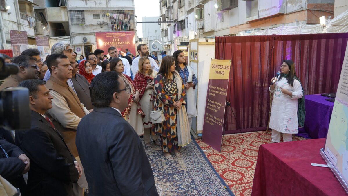 Audience engrossed in a presentation about Dawr al-Satr