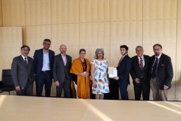 Members of the Keshavjee family present artefacts to the IIS