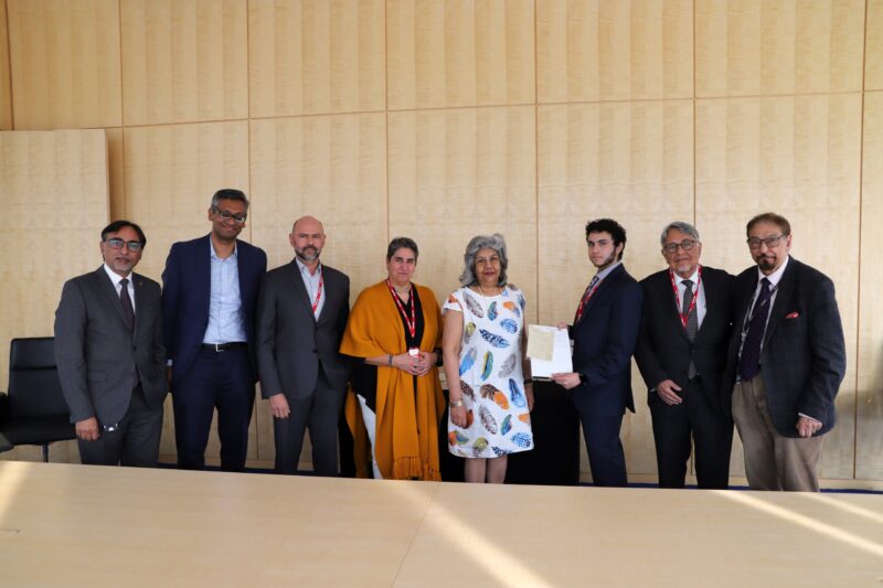 Members of the Keshavjee family present artefacts to the IIS