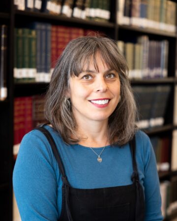 Julie Feiler in library with books behind