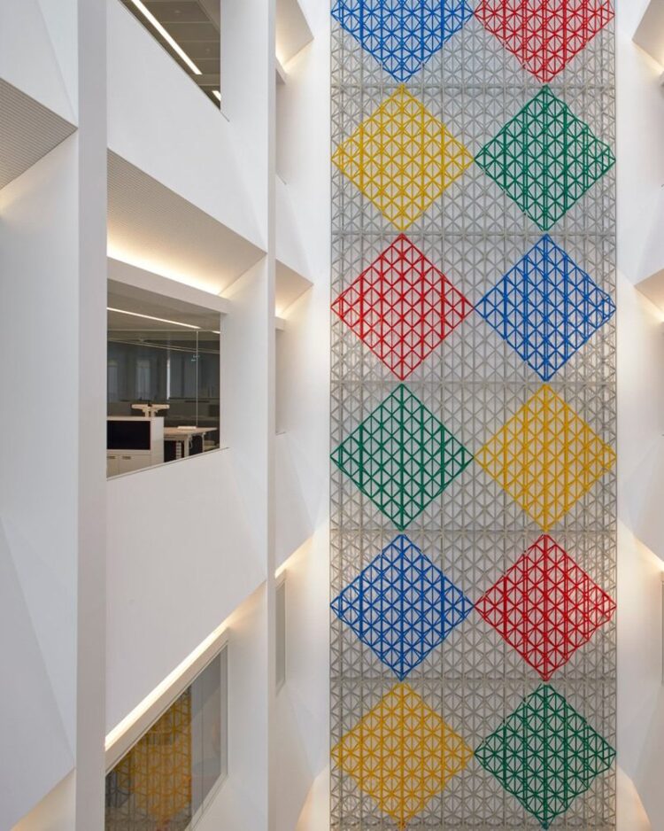 a multicolored wall with a pattern on the wall