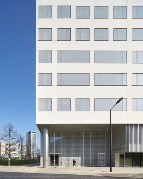 a building with a person walking in front of it