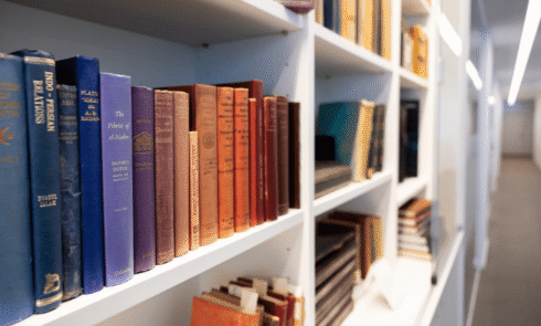 a row of books on a white shelf