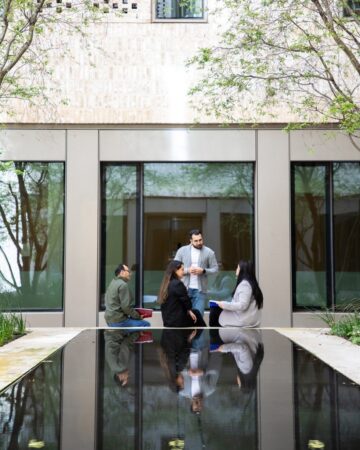 a group of students sitting outside a building