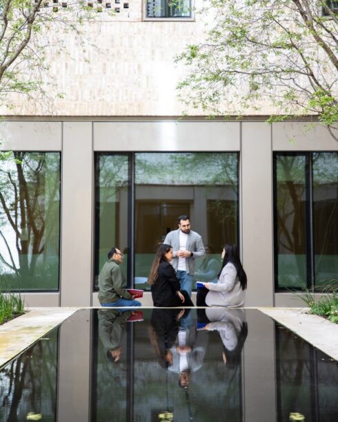 a group of students sitting outside a building