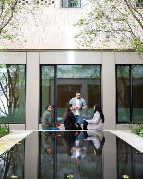 a group of students sitting outside a building