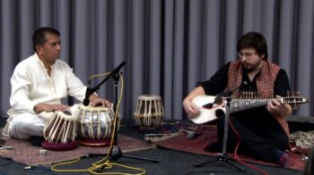 Musicians playing traditional Rubab and Tabla instruments together.