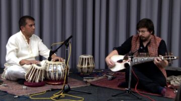 Musicians playing traditional Rubab and Tabla instruments together.