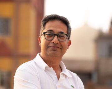 Man in white shirt outdoors.