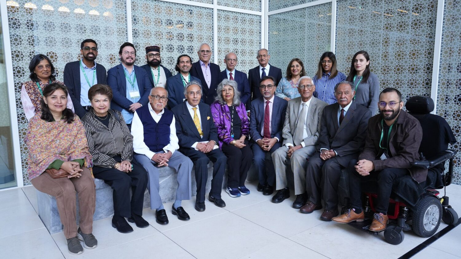 Diverse group posing for conference photo.