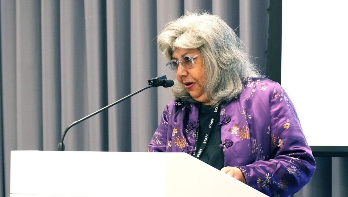 Speaker presenting at a conference.