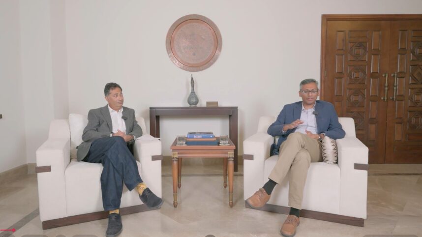 Dr Wafi Momin and Dr Fayaz Alibhai seated in a discussion setting during a recorded conversation on Ismaili heritage preservation.