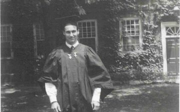 His Late Highness Aga Khan IV at his Harvard University Graduation, wearing academic gown. Ismaili Special Collections