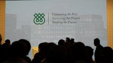 Stage backdrop at the Global Encounters Festival 2025 with attendees in silhouette.