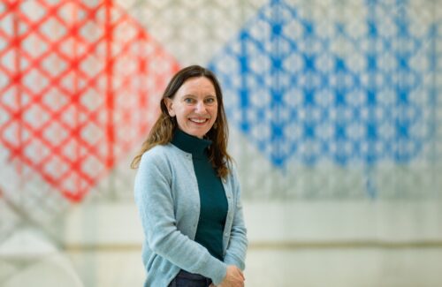 Karen Bauer at the Aga Khan Centre with geometric artwork in the background