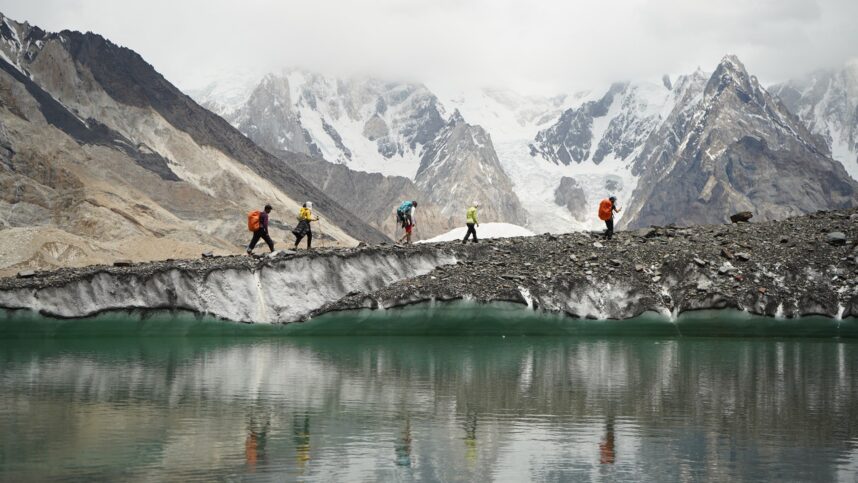 Hikers crossing a glacial landscape. Voices connected