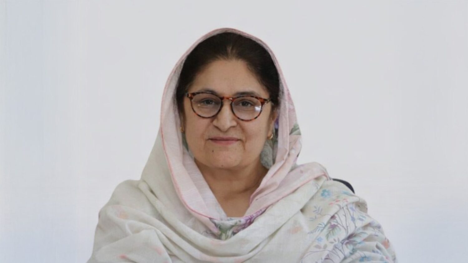 Woman wearing a traditional shawl. Dr Dil Angaiz during an Oral History interview in Gilgit, 2023